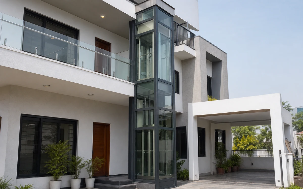Telescopic home lift on villa exterior with glass shaft