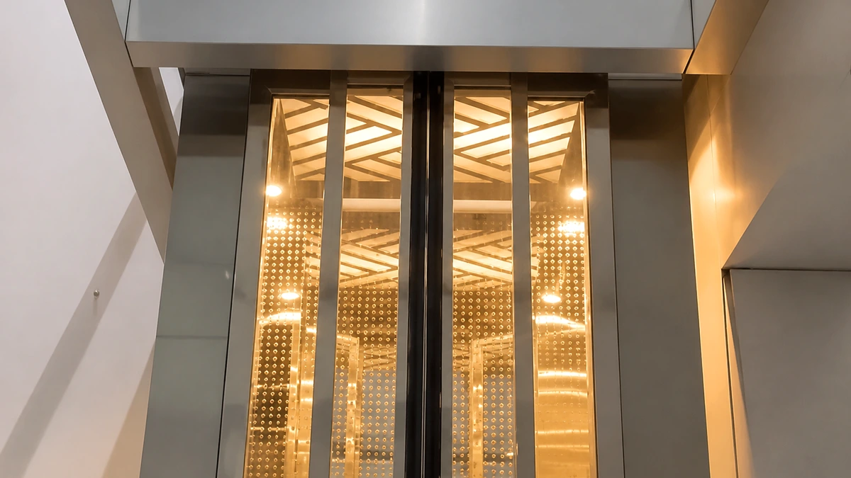 Bespoke gold and glass custom lift cabin with designer ceiling — Great India Elevator